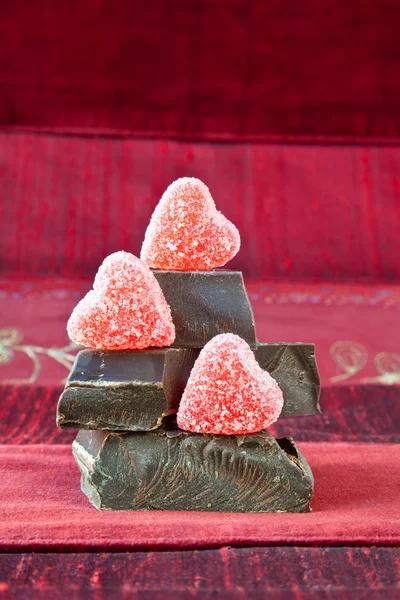 stock image Candy Hearts on a Pile of Dark Chocolate Pieces