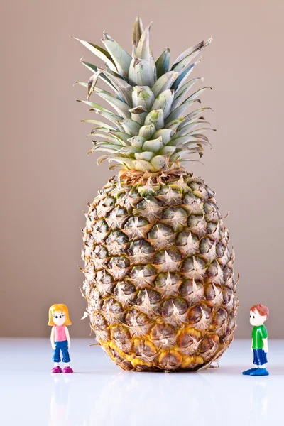 Menina e menino impressionado por escolhas nutricionais (abacaxi ) — Fotografia de Stock