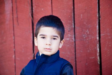 Serious Little Boy Making Eye Contact clipart