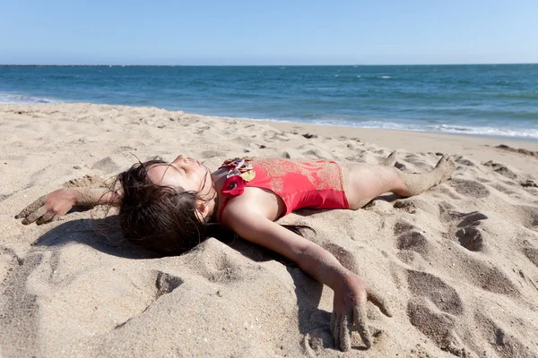 stock image Little Girl Relaxing on the Beach Covered in Sand