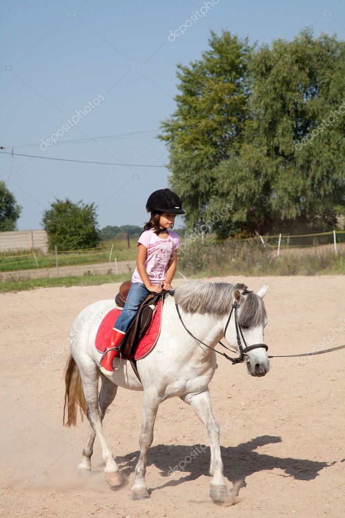 Little Girl Taking Horseback Riding Lessons Stock Photo by ©DashaRosato ...