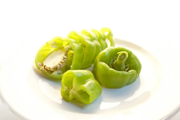 Fresh green peppers, garlic, and onion on bright white background — Stock Photo, Image