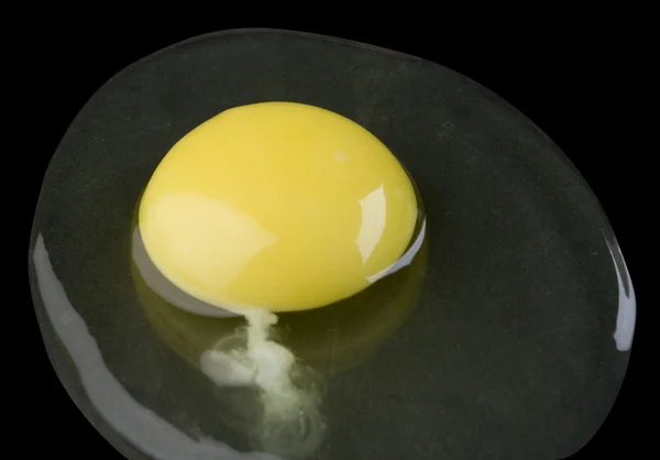 Broken egg isolated on black — Stock Photo, Image