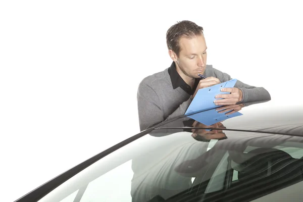 stock image Male assessor writing on clipboard