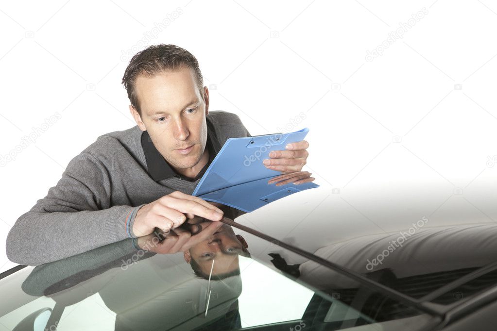 Insurance agent looking at a car