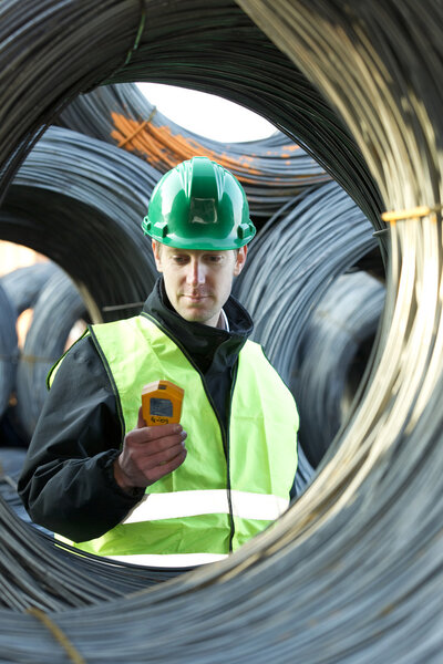 Supervisor Inspecting With Geiger Counter
