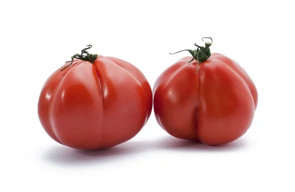 Два красных неклассических помидора — стоковое фото
