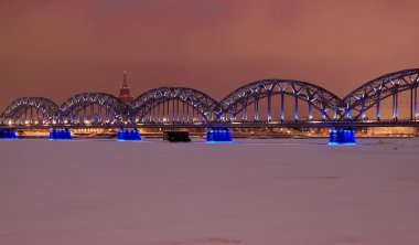 Riga railway bridge at night time clipart