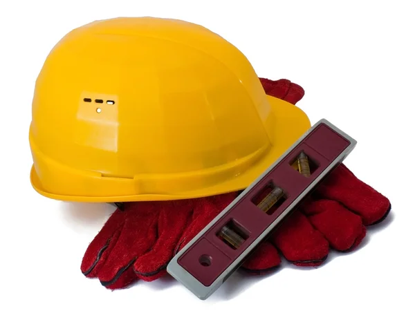 Stavební přilbu, rukavice a úroveň — Stock fotografie
