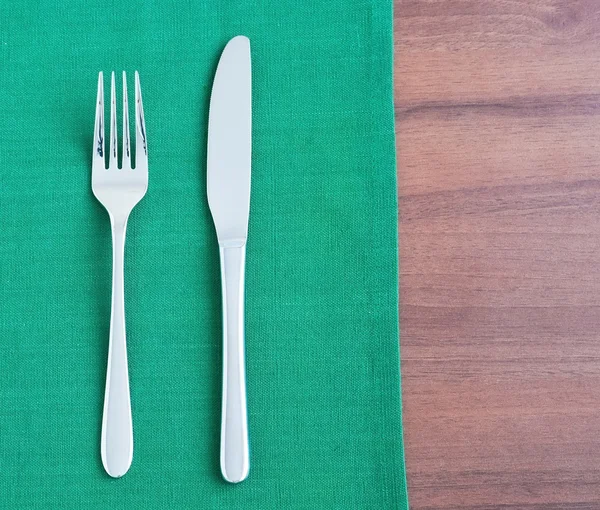 Silverware on the green napkin — Stock Photo, Image