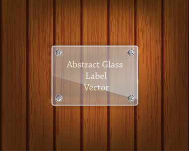 Glass label on screws on the wooden background clipart