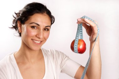 Smiling woman with red apple in tape measure clipart