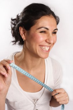 Smiling woman with tape measure in hands clipart