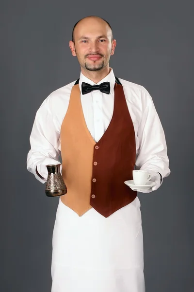 Waiter with percolator and cup of coffe — Stock Photo, Image
