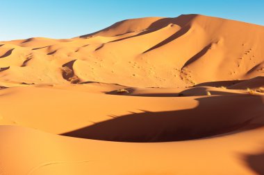 Sand dunes and blue sky clipart