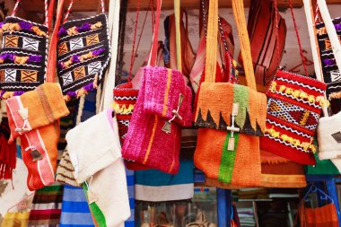 Colorful bags in a market in the street clipart