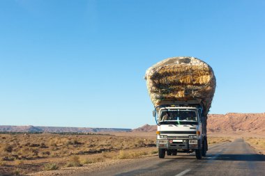 Overloaded truck on highway, morocco clipart
