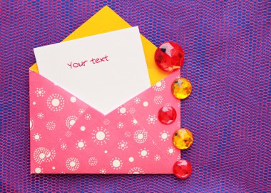Pink envelope with white circles and a note clipart