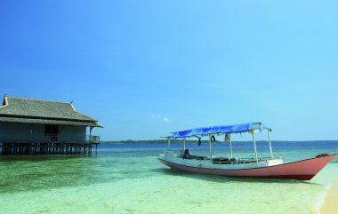 Small ship anchor on beach at karimunjawa clipart