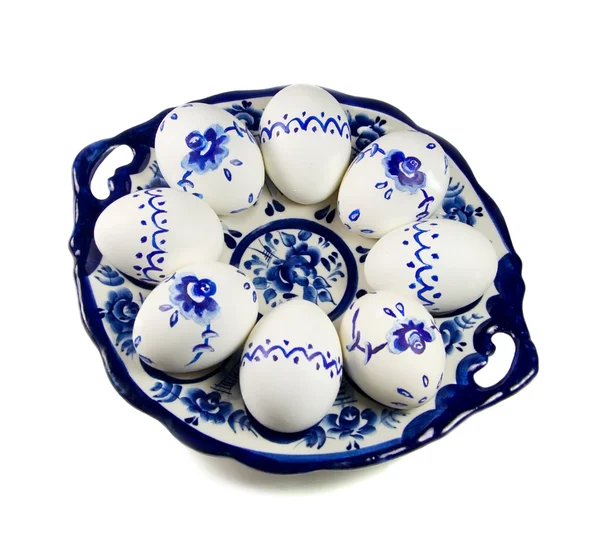 Stock image Plate with painted Easter eggs on white background