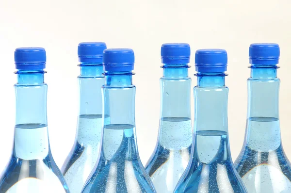 Close up of gas water bottles on a white background — Stock Photo, Image