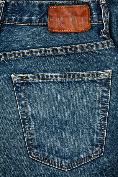 Blue Jeans Stoff mit Tasche und Etikett — Stockfoto