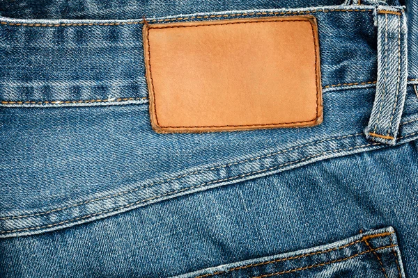 Étiquette de jeans en cuir blanc cousue sur un jean bleu — Photo
