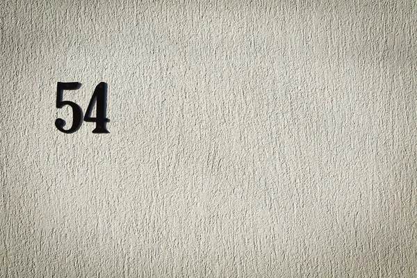 Número 54 na parede de cimento — Fotografia de Stock