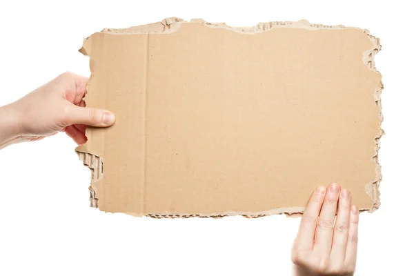 Hands holding cardboard — Stock Photo, Image