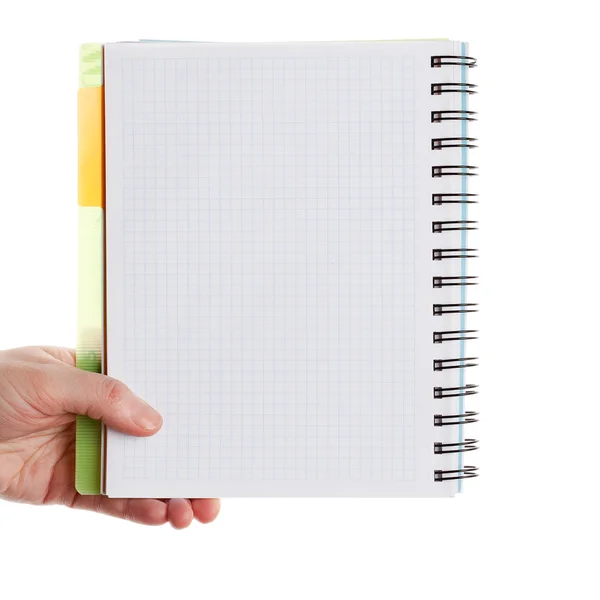 Mão segurando caderno espiral — Fotografia de Stock
