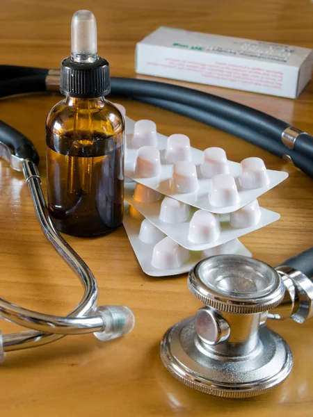 Stock image Stethoscope and blister pills wiyh bottle dropper