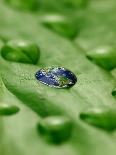 Earth in water drops on a green leaf — Stock Photo, Image