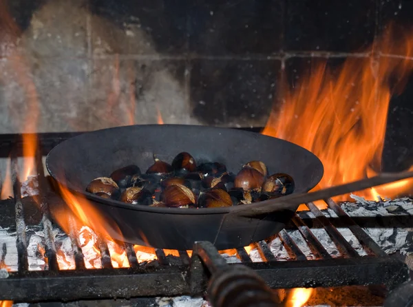 stock image Roasted chestnuts in the fireplace