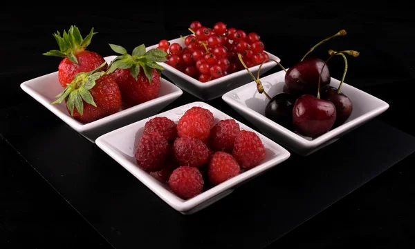 Fresh red fruit on black background — Stock Photo, Image