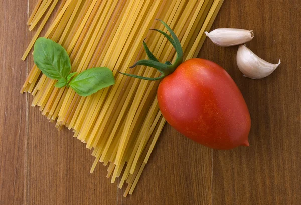 stock image Raw spaghetti with tomato a garlic and basil