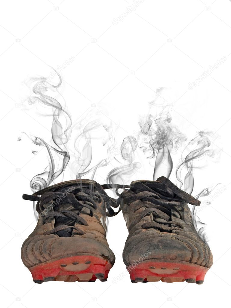 Dirty footbal shoes with smoke