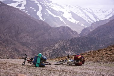 Two bicycles on a mountain pass clipart