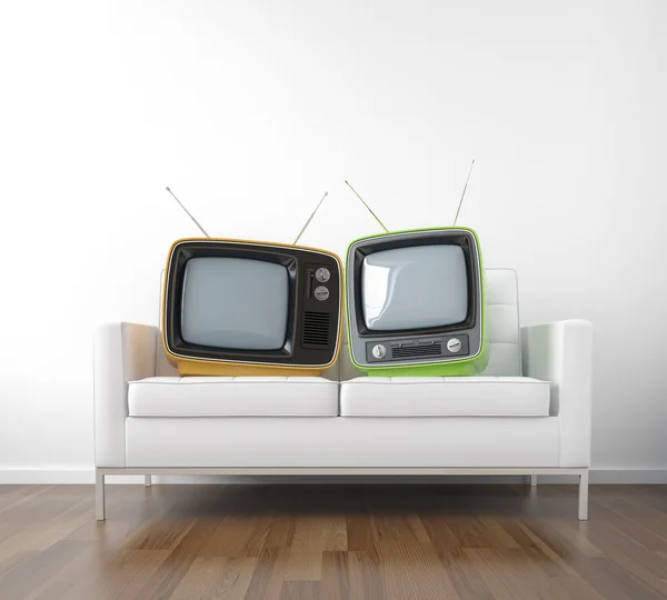 Два ретро-телевизора на диване — стоковое фото