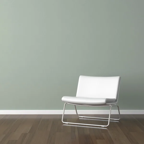 Белый современный стул на зеленой стене — стоковое фото