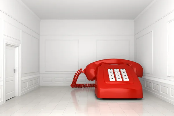 Duży czerwony telefon w białym pustym pokoju — Zdjęcie stockowe