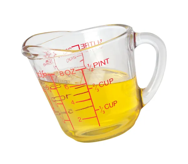 Koken olie in meten cup met een uitknippad — Stockfoto