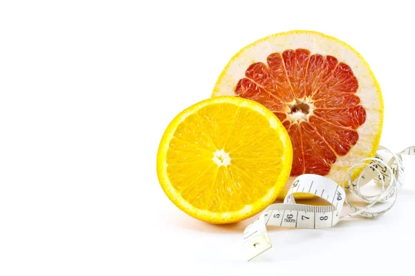 Slice of grapefruit and orange with tape measure — Stock Photo, Image