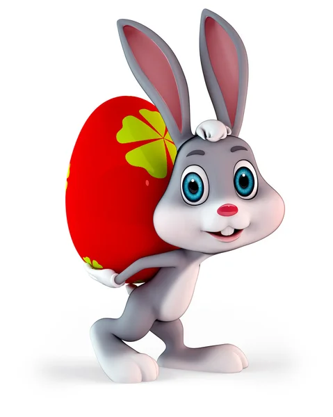 Easter bunny with heavy colorful red egg — Stock Photo, Image