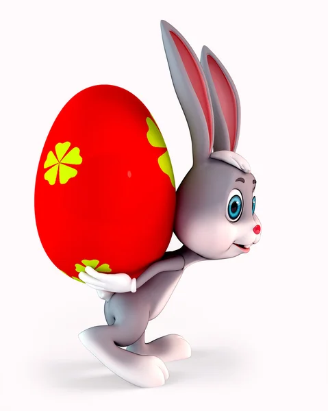 Easter bunny with heavy colorful red egg — Stock Photo, Image