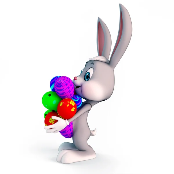Conejito feliz con un montón de huevos de colores — Foto de Stock