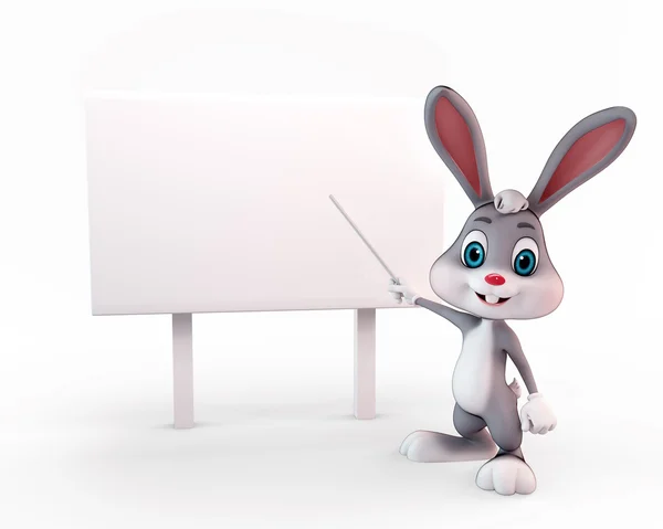 Happy Bunny pointing towards sign — Stock Photo, Image