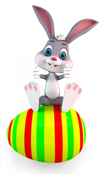 Bunny sitting on a egg — Stock Photo, Image