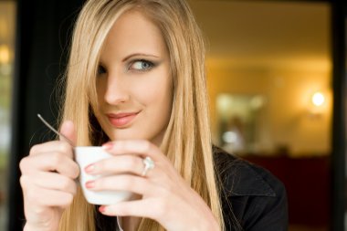 Elegant young blond woman on cofffee break. clipart