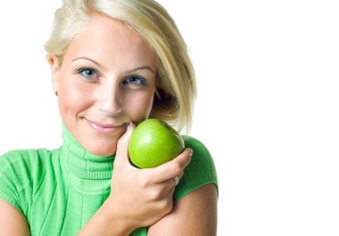 Beautiful young blonde girl hodinga green apple smiling at the c clipart