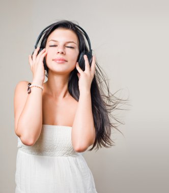 Beautiful brunette music lover. clipart